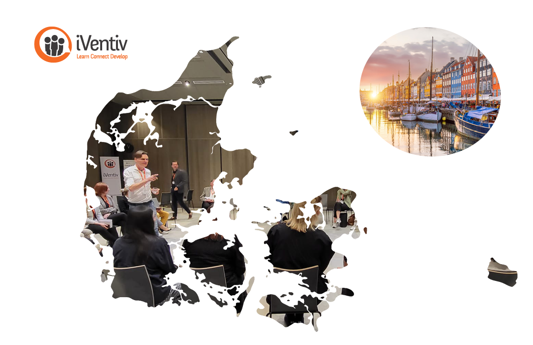 A group of participants in conversation inside a map of Denmark