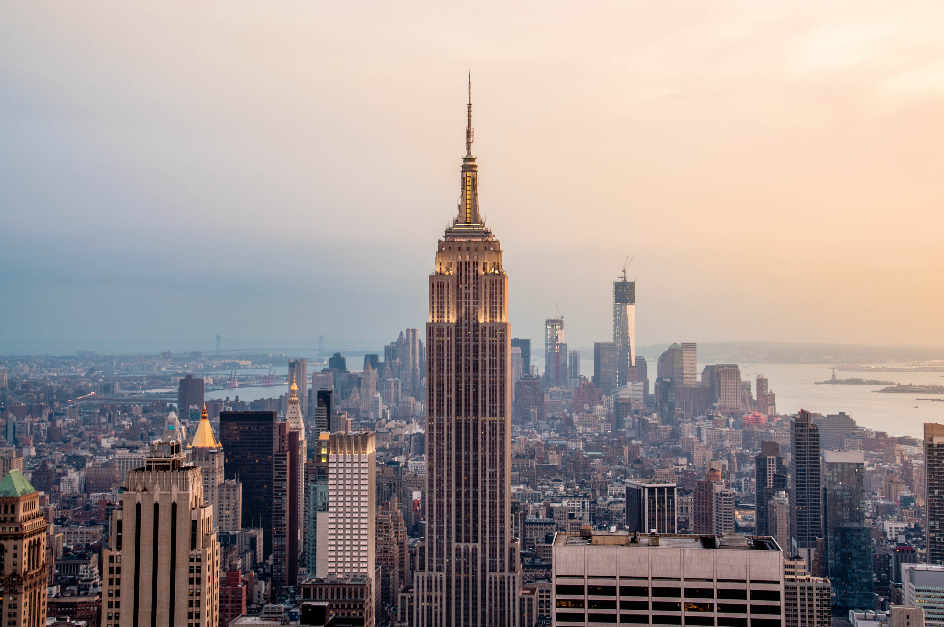 The empire state building against the new york skyline at sunset