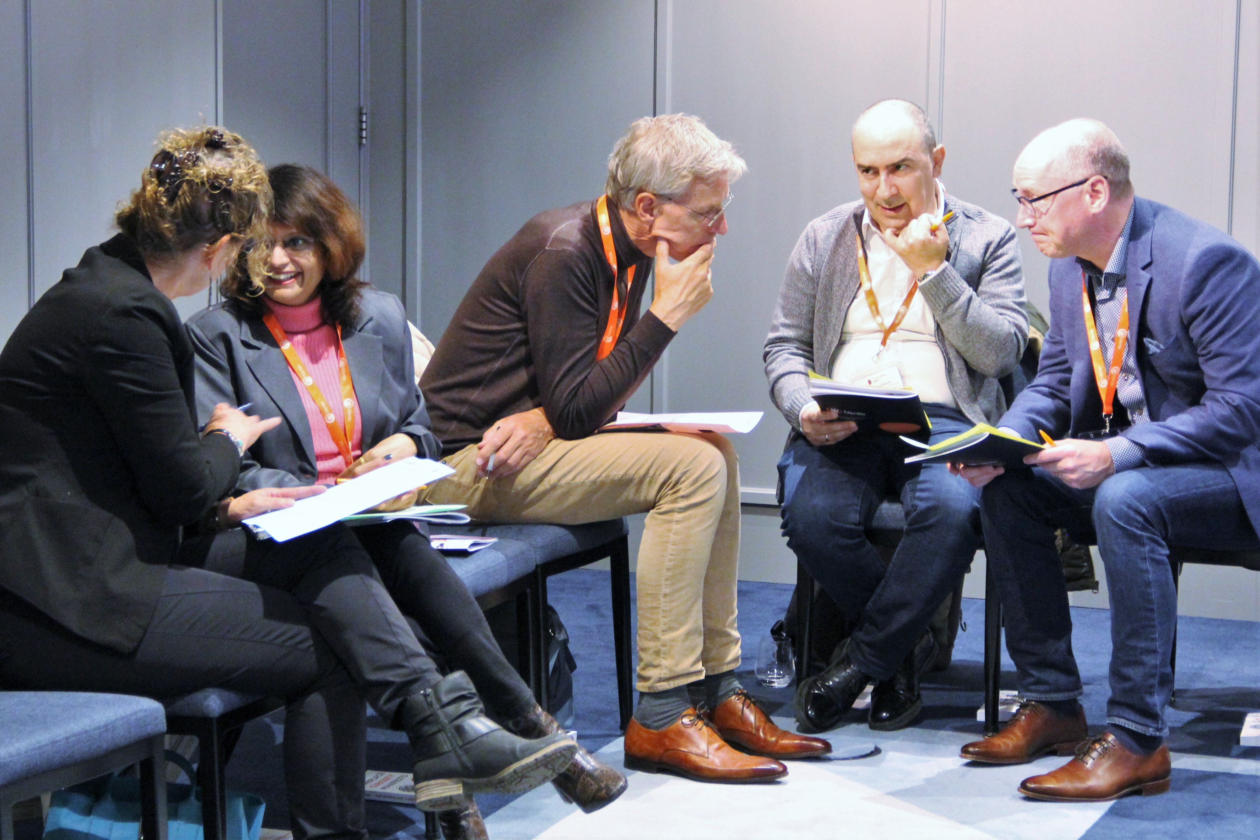 Five participants smiling and talking at an iVentiv event in Amsterdam in June 2022