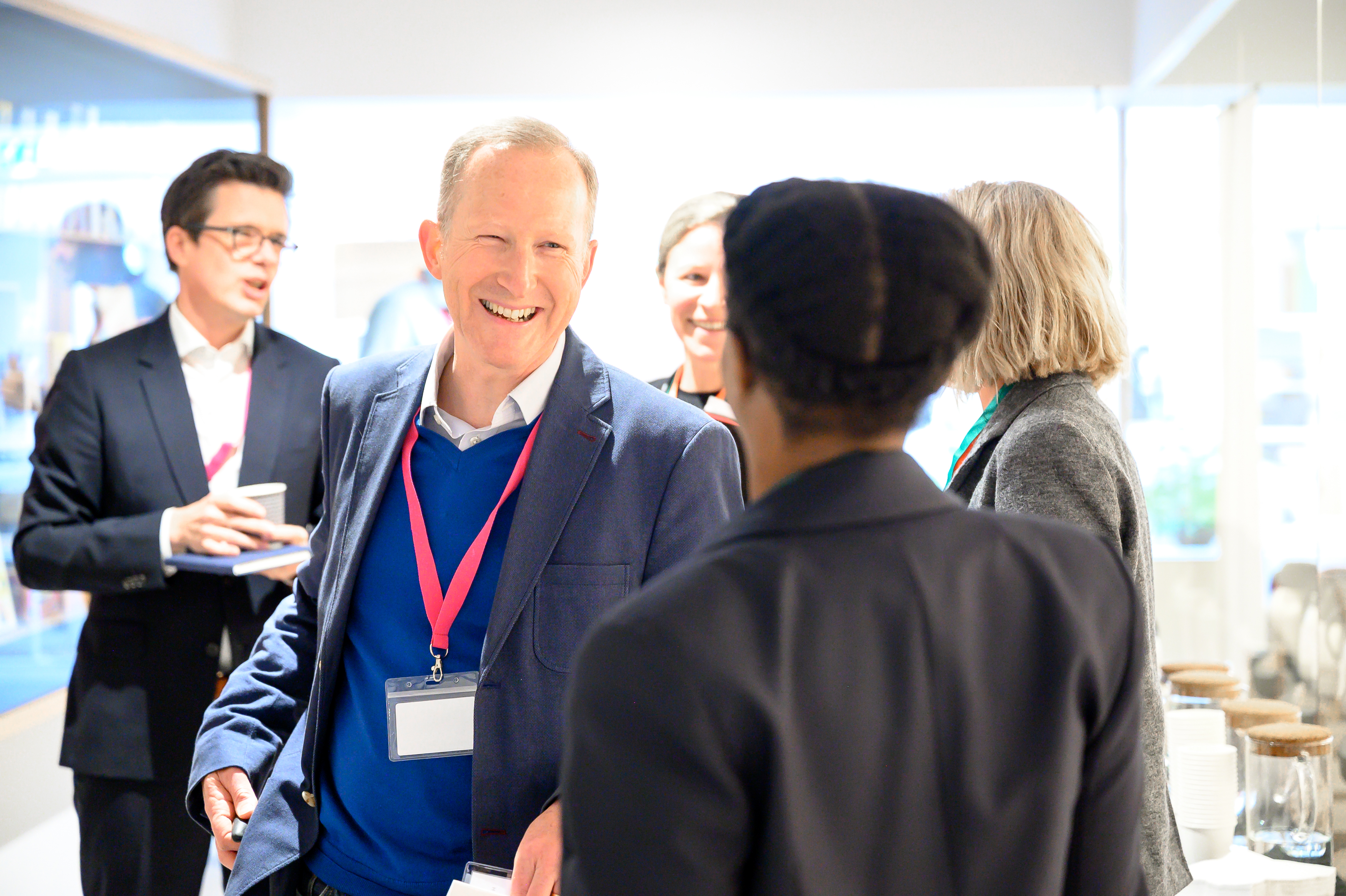 A man arrives to an iVentiv event, smiling