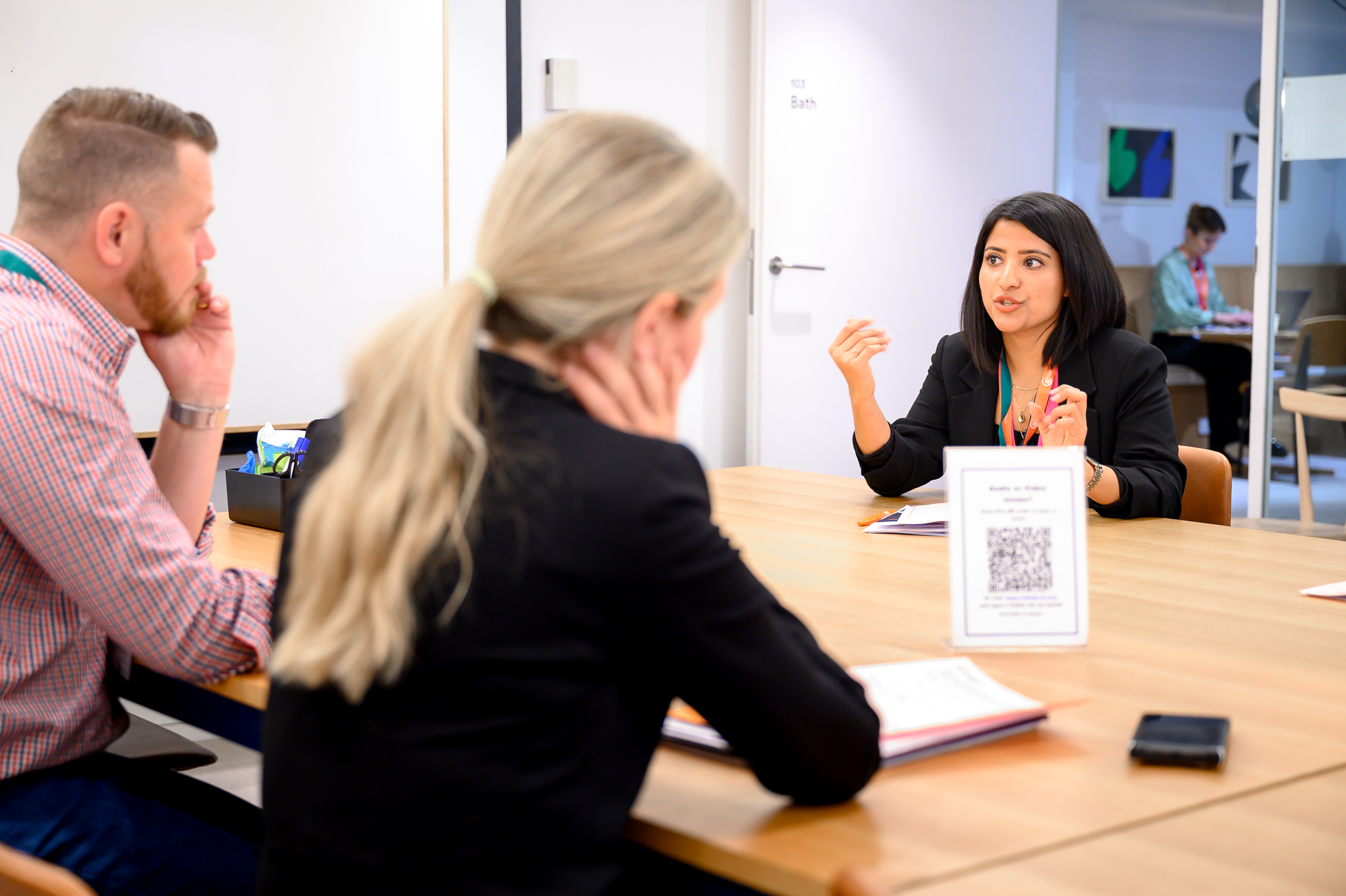 Three participants in conversation at an iVentiv event in 2022